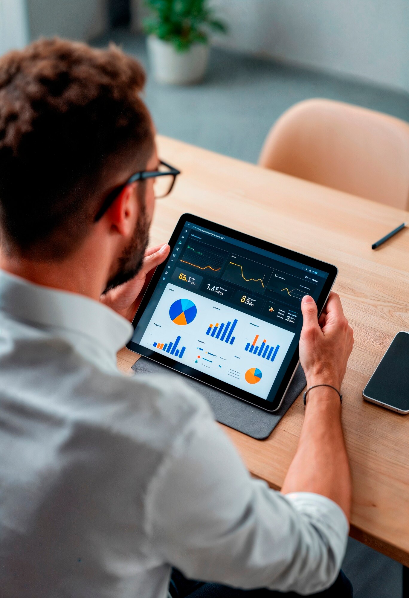 man-is-looking-tablet-that-has-graph-graph-it_23-2151929050